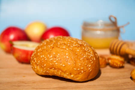 Symbols of the Jewish New Year. Apple, honey, Shofar, challah close up.の写真素材