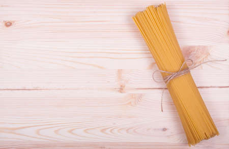 Bunch of spaghetti tied with rope isolated on white backgroundの写真素材