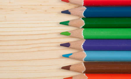 Sharpened colored pencils on wood desk. Office suppliesの写真素材
