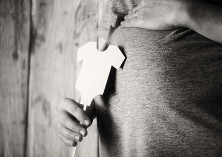 Pregnant woman with present for infant baby. Waiting for the childの写真素材