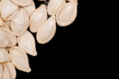 Pumpkin seed on black background close up. Food ingredientsの写真素材
