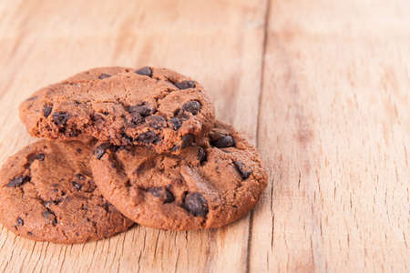 Chocolate biscuit with chocolate drop on wood desk. Dessertsの写真素材