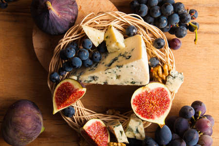 Blue cheese with fruits. Grape, pitahaya, fig.の写真素材