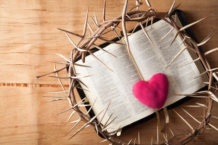Crown of thorns with blood and Bible on white backgroundの写真素材