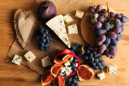 Blue cheese with fruits. Grape, pitahaya, fig.の写真素材