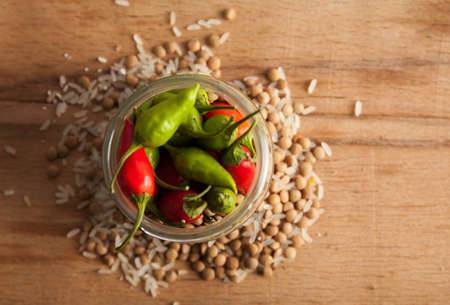 Raw lentils and rice with chilli pepper.の写真素材