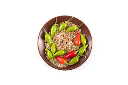Raw lentils and rice with chilli pepper isolated.の写真素材