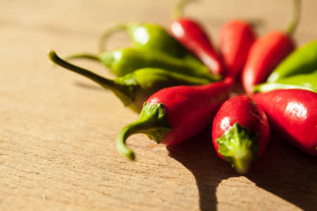 Small chilli pepper close up on wood desk.の写真素材