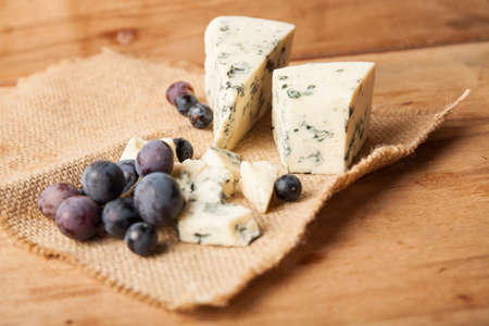 Blue cheese with grape close up.の写真素材