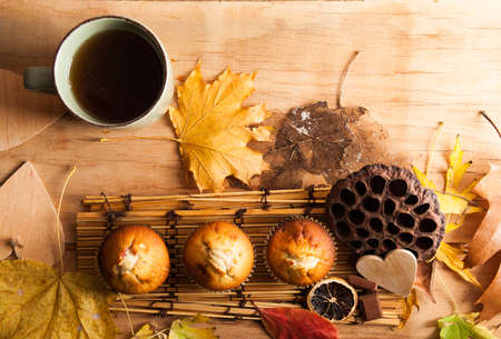 Fresh muffin close up on wood desk. Autumn compositionの写真素材