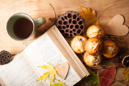 Fresh muffin close up on wood desk. Autumn compositionの写真素材