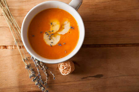 Pumpkin puree soup in bowl on wood desk. Health foodの写真素材