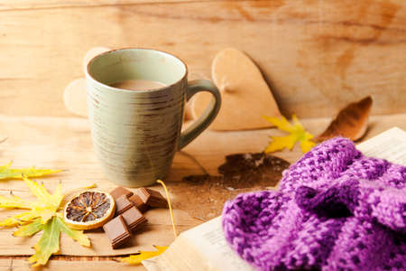 Autumn composition with cup coffee and yellow leaf.の写真素材