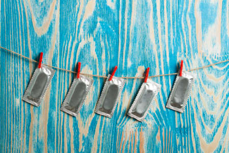 Thumb and condom over  on wood desk. World AIDS Dayの写真素材