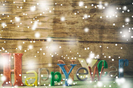 Christmas decoration on wood desk. Happy new year writtenの写真素材