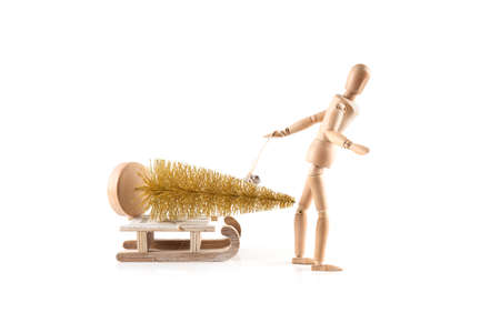 Wood figure with sleigh and gold christmas tree isolated on white background. の写真素材