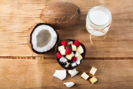 Ripe coconut and coconut oil close up on wood desk. Food ingredientsの写真素材