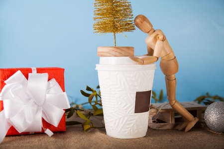 Disposable coffee cup close up and wood figureの写真素材