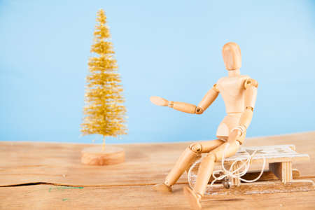Wood figure with sleigh and gold christmas tree isolated on white background. の写真素材