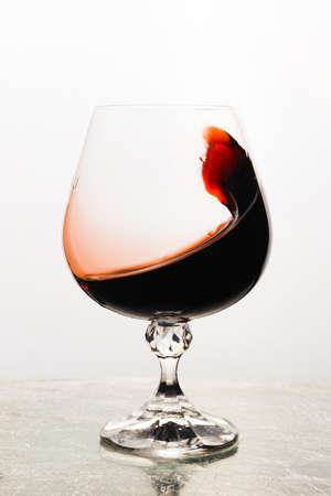Red wine in a glass isolated on white backgroundの写真素材