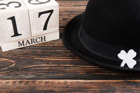 Save the date white block calendar for St Patrick's Day with Leprechaun on wood deskの写真素材