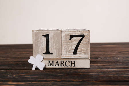 Save the date white block calendar for St Patrick's Day with Leprechaun on wood deskの写真素材