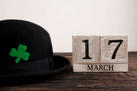 Save the date white block calendar for St Patrick's Day with Leprechaun on wood deskの写真素材