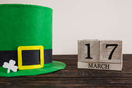 Save the date white block calendar for St Patrick's Day with Leprechaun on wood deskの写真素材