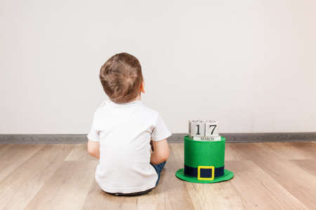 Little boy with Leprechaun hat on white background. St Patrick's Day.