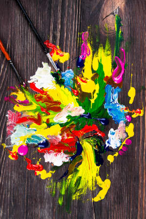 paints with brushes on wood desk. holiの写真素材