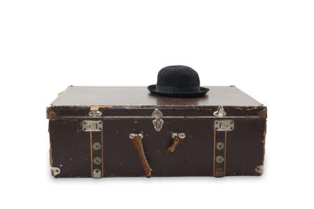 Suitcase and black hat isolated on white backgroundの写真素材