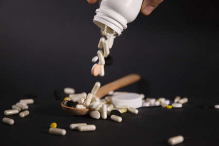 Pills close up on black background. Medical concept