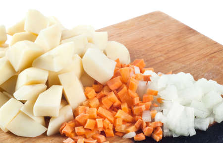 sliced vegetables on a board isolated on whiteの写真素材