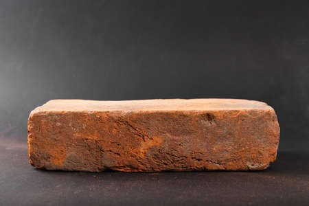 Red brick close up isolated on black backgroundの写真素材