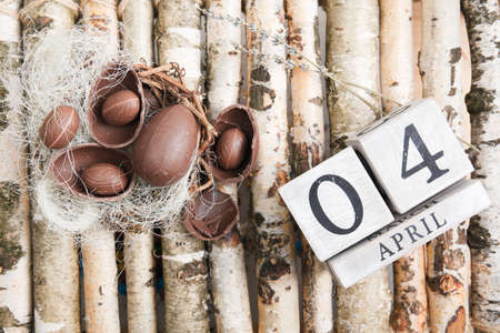 Chocolate eggs on wood desk. Happy easterの写真素材