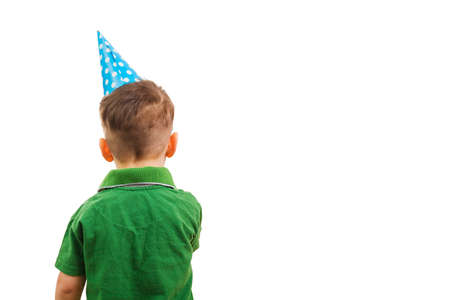 Boy in a festive cone and a clown's nose on white background. Fools dayの写真素材
