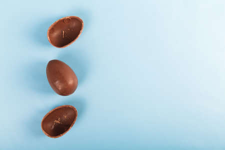 Chocolate eggs on blue background. Happy easterの写真素材