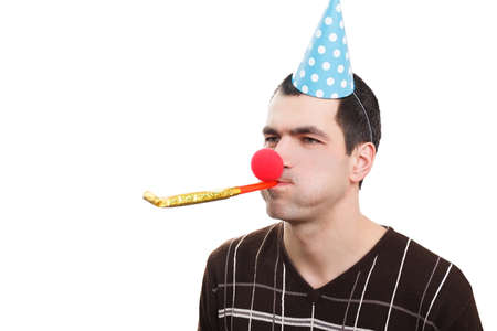 Man in a festive cone and a clown's nose on white background. Fools dayの写真素材