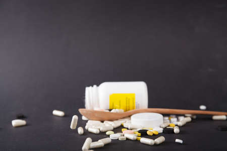 Tablets and capsules are scattered on the table. Healthcare conceptの写真素材