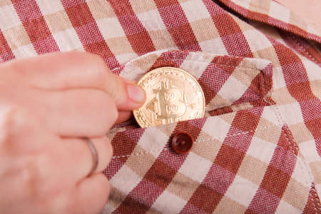 Bitcoin close up in hand. Concept of development of the crypto currencyの写真素材