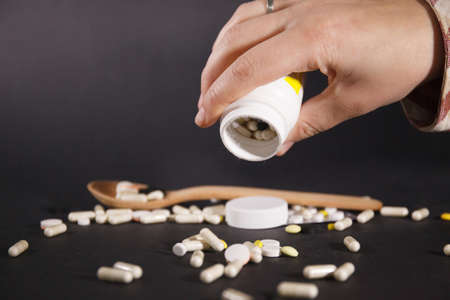 Tablets and capsules are scattered on the table. Healthcare conceptの写真素材