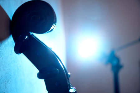 Cello in dark room with club light. Poster for concertの写真素材