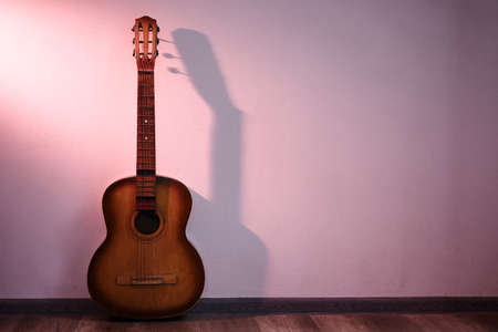 Old guitar in empty room. Concert hall
