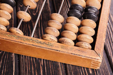 Vintage abacus on wooden background. Business concept