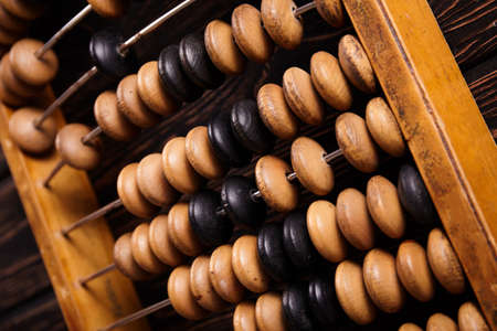 Vintage abacus on wooden background. Business concept