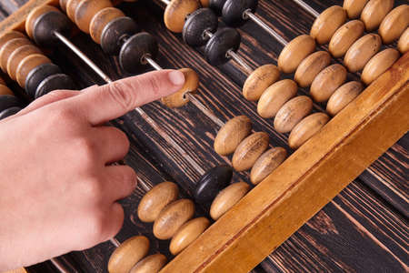 Vintage abacus on wooden background. Business concept