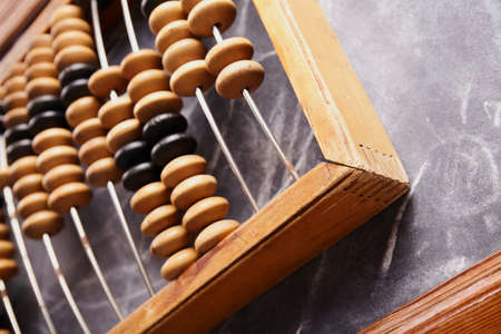 Vintage abacus on wooden background. Business concept