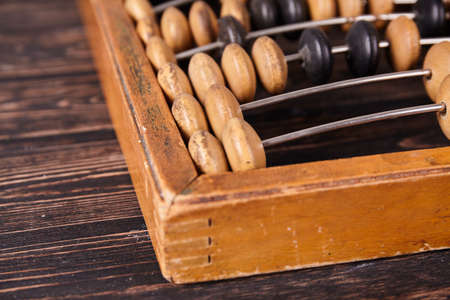 Vintage abacus on wooden background. Business concept