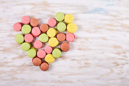 Fresh colored macaroons on wood desk. Food backgroundの写真素材
