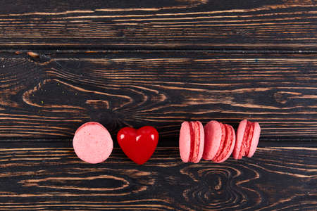 Fresh colored macaroons on wood desk. Food backgroundの写真素材